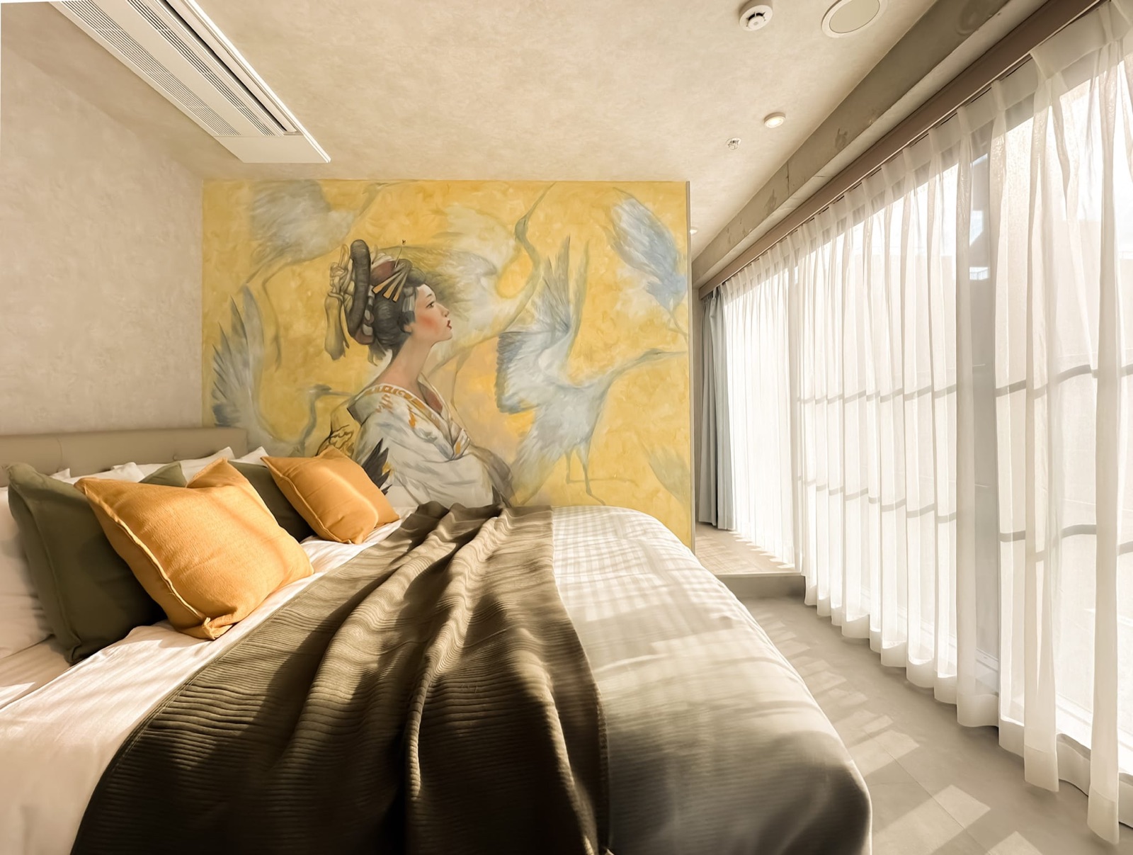 Guest room at LANG HOTEL Asakusa with a hand-painted mural